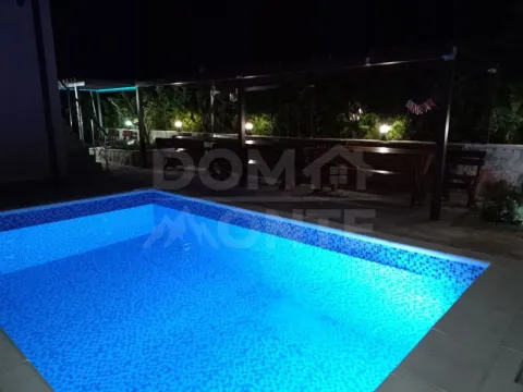 Illuminated swimming pool in the courtyard of the house at night. - image 10