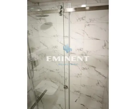 Modern shower cabin with marble tiles and a glass screen. - image 6