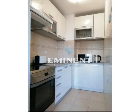 Small bright kitchen with white units and built-in kitchen appliances. - image 6