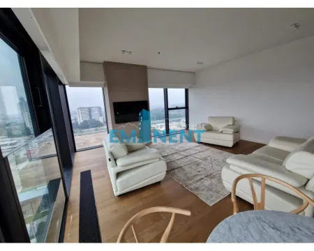Spacious living room with seating furniture and large windows with a city view. - image 2