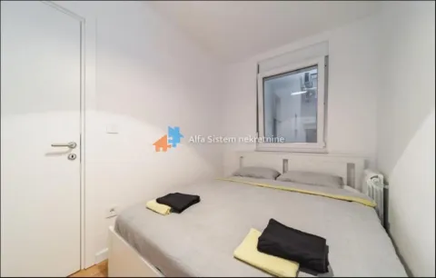 Smaller bedroom with a white bed and a window. - image 7