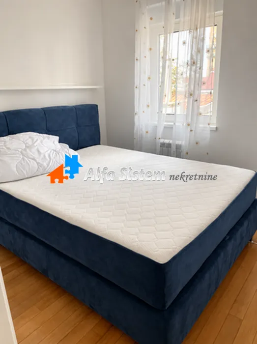 Bedroom with a double bed and a window.