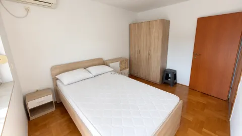 Furnished bedroom with a double bed, wardrobe, and nightstands. - image 6