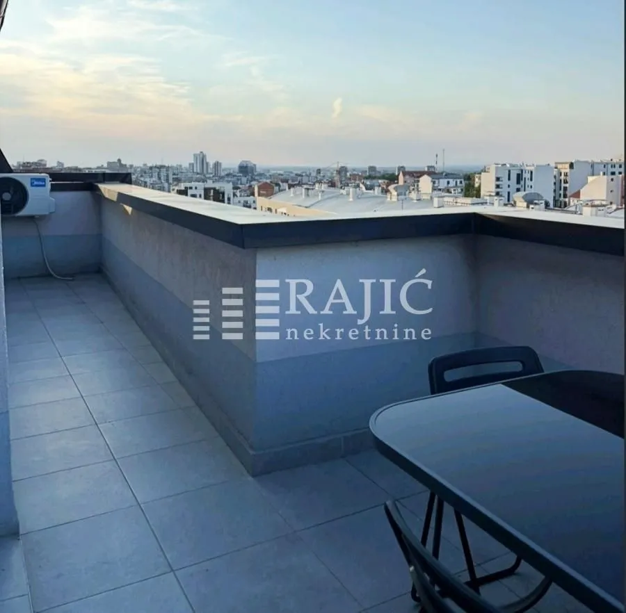 Spacious terrace with seating furniture and city views.