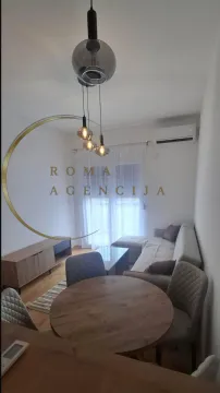 Bright living room with a dining area and modern lighting. - image 4