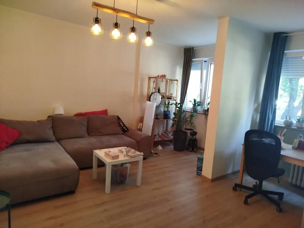 Dnevna soba sa garniturom, stočićem i radnim kutkom.