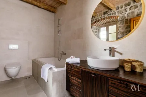 Modernly equipped bathroom with a bathtub, washbasin, and wooden elements. - image 12