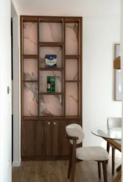Modern interior featuring a lighted wooden display cabinet and a dining table. - image 9