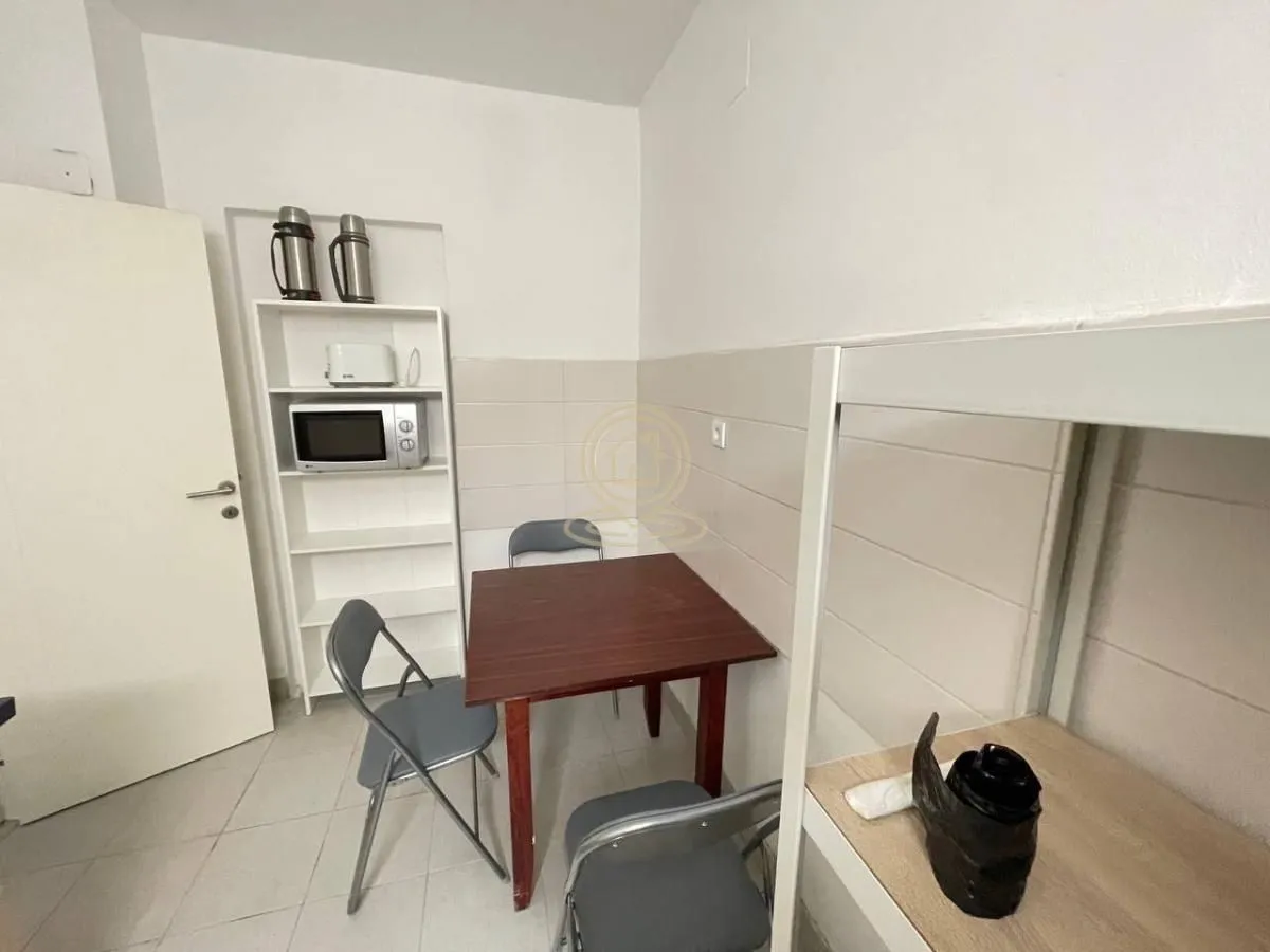 Small kitchen with a dining table and chairs.
