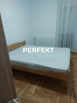 Bedroom with a double bed and parquet flooring. - image 10