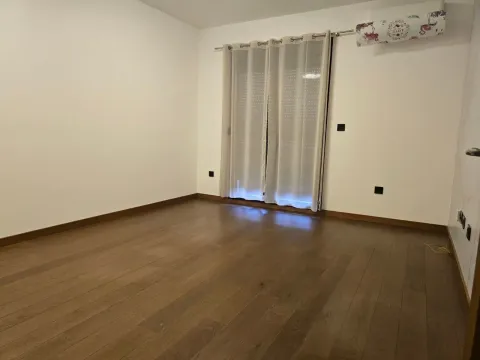Empty room with wooden flooring and balcony doors. - image 6