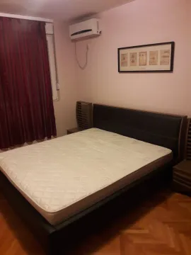 A simple bedroom with a double bed and air conditioning. - image 10