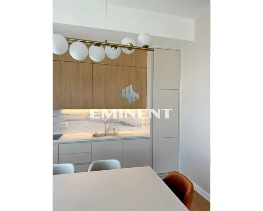 Modern kitchen with built-in cabinetry and a dining table.