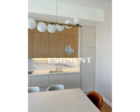 Modern kitchen with built-in cabinetry and a dining table. - image 5
