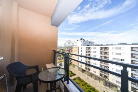 Covered balcony with seating furniture and a view of surrounding buildings and the city. - image 11