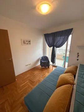 Living room with a sofa and access to the balcony. - image 4
