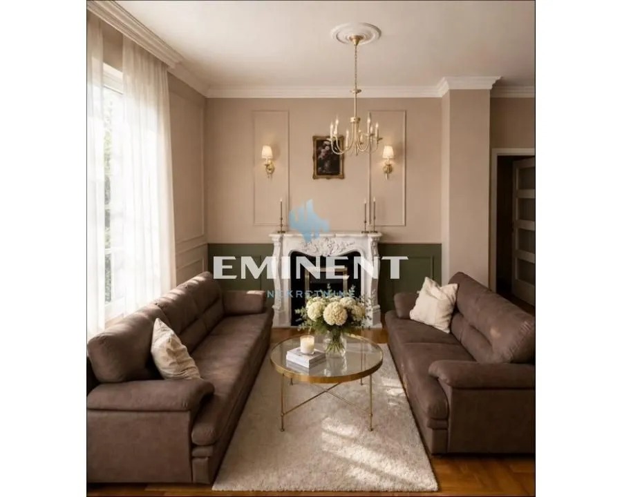 Living room furnished with two brown sofas, a fireplace, and a round coffee table.