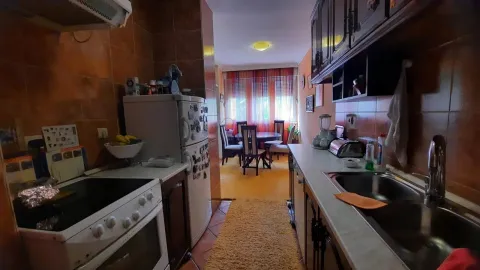 Kitchen with a dining area in the background. - image 9