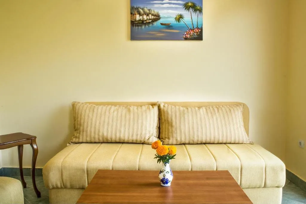 Living room with a sofa, coffee table, and a painting on the wall.