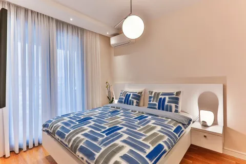 Bright bedroom with a modern bed and decorative lighting. - image 3