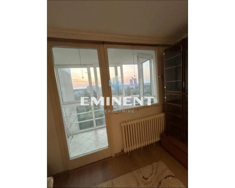 View of the enclosed balcony with access from the room.
