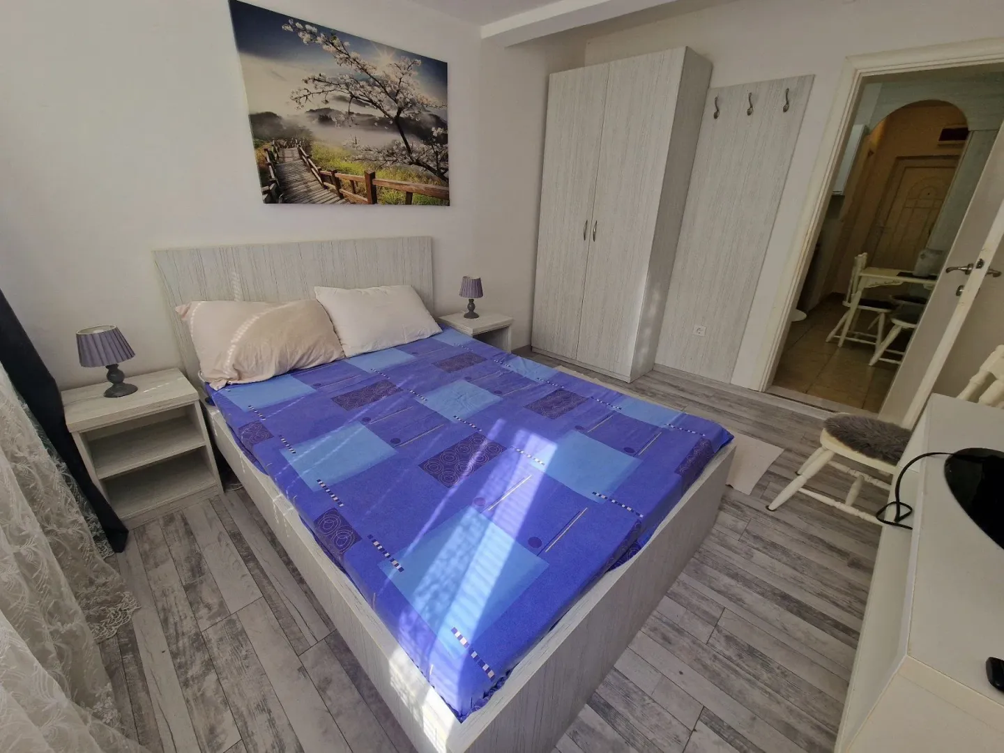 Furnished bedroom with a double bed, wardrobe, and nightstands.