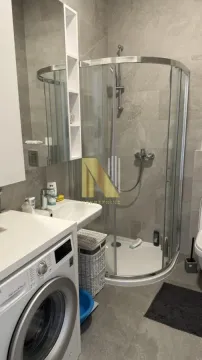 Savremeno opremljeno kupatilo sa tuš kabinom i veš mašinom. - image 7
