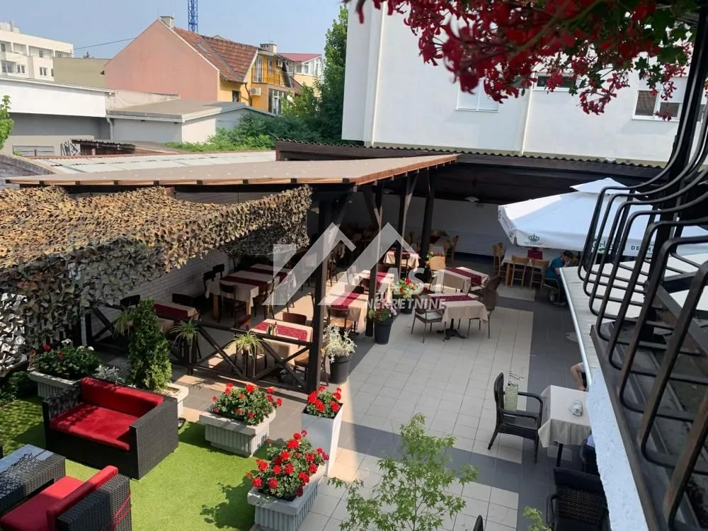 View of the landscaped courtyard and terrace with tables and seating area.