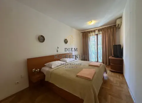 Bedroom with a double bed, wooden flooring, and access to a balcony. - image 4