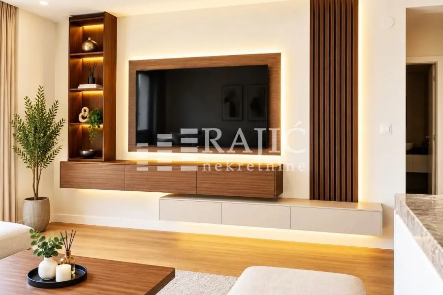 Modern living room with a TV unit and ambient lighting.