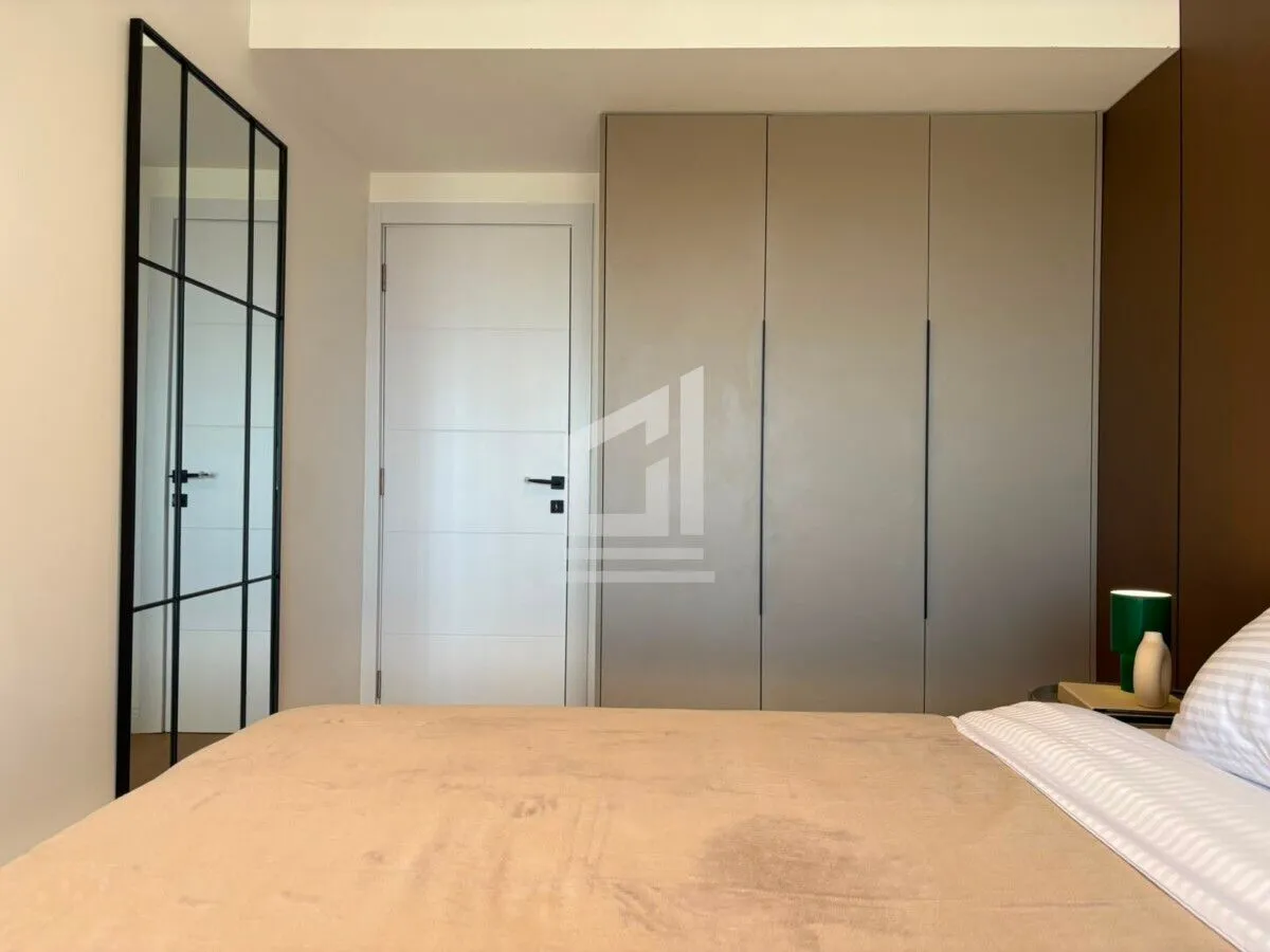 Bedroom with a double bed, large wardrobe, and a mirror.