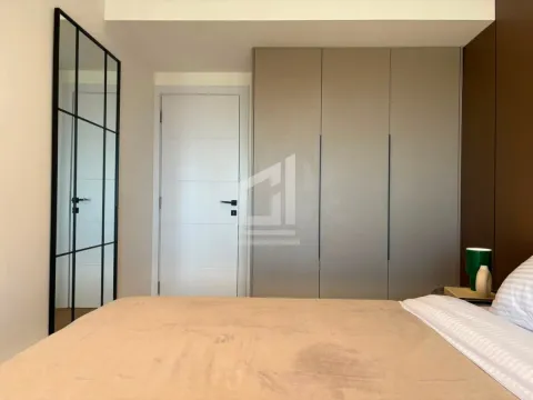 Bedroom with a double bed, large wardrobe, and a mirror. - image 4