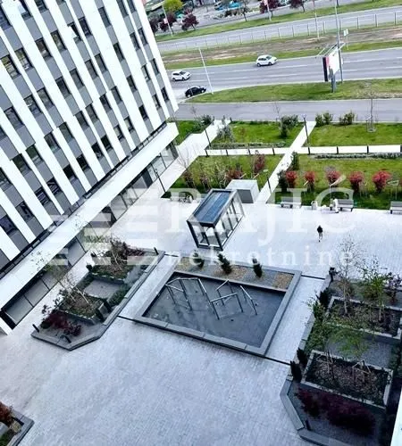 High-angle view of the landscaped courtyard in front of the building with greenery.