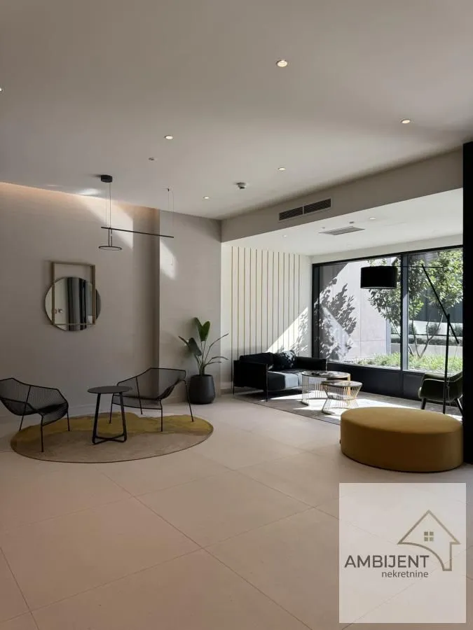 Spacious bright living room with modern furniture and large windows.
