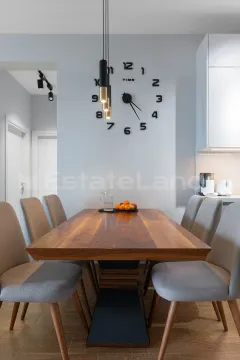 Trpezarija sa drvenim stolom i modernim stolicama u sklopu kuhinje. - image 8