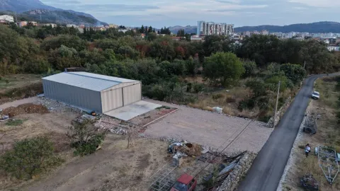 Aerial view of the warehouse and surrounding land with a road. - image 2