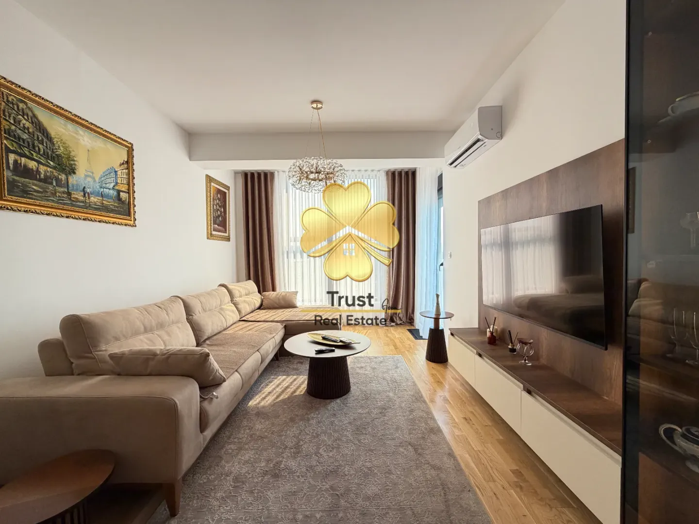 Modern and bright living room with a sofa and TV unit.
