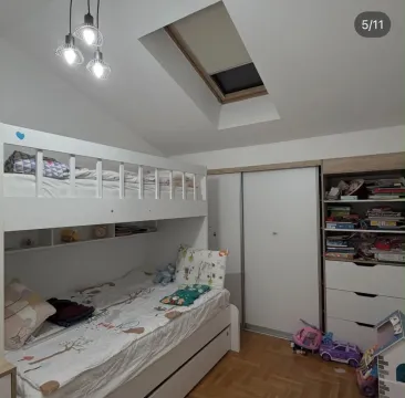 Children's bedroom with a bunk bed, wardrobe, and roof window. - image 4