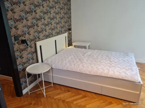 Bedroom with a double bed and patterned wallpaper. - image 9
