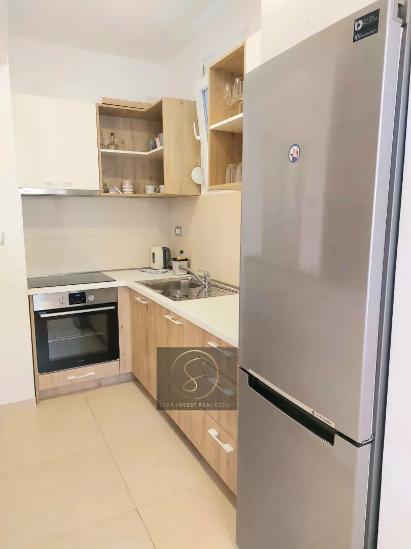 Small modern kitchen with wood-tone and white cabinetry.