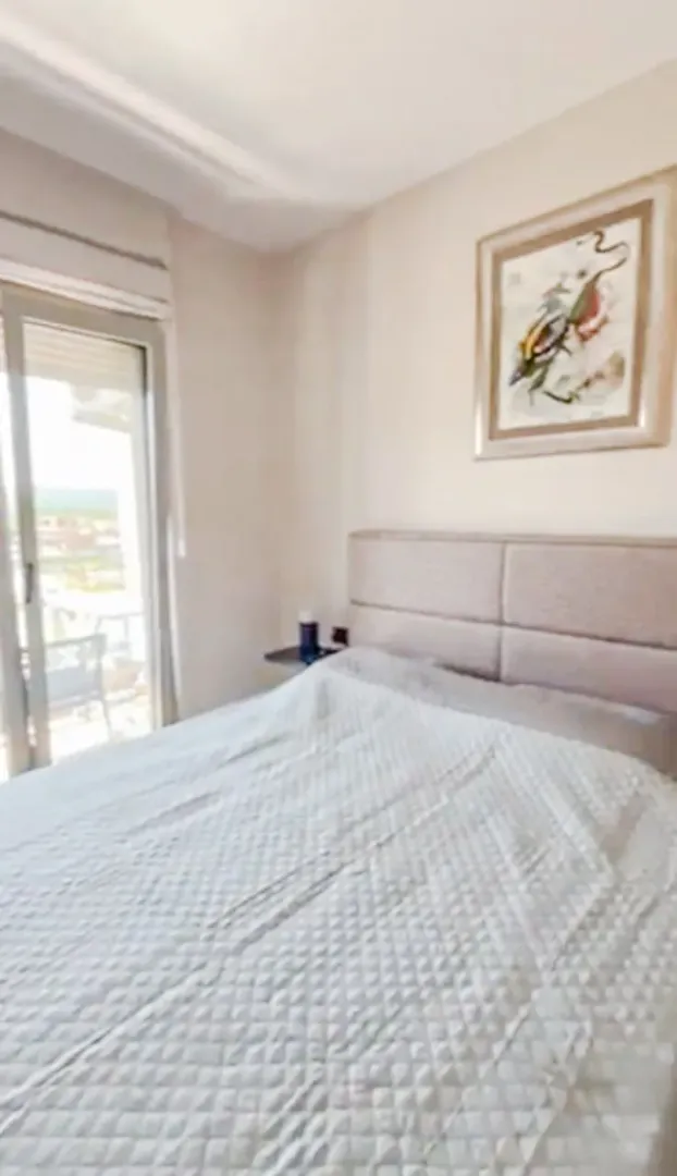 Comfortable bedroom with a double bed and access to the terrace.