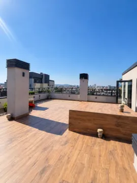 Large spacious terrace with wooden flooring and city views. - image 6