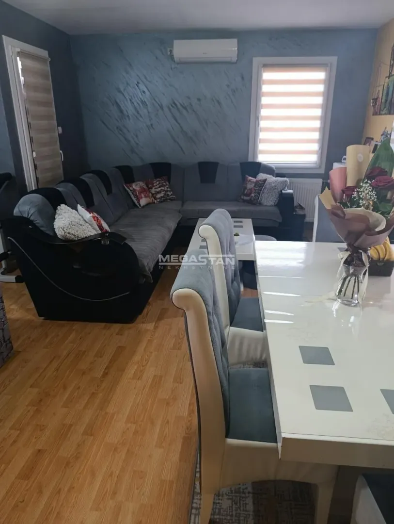 Living room with a sectional sofa and a dining table.