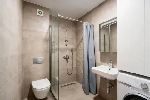 Modernly equipped bathroom with a walk-in shower and a sink. - image 9