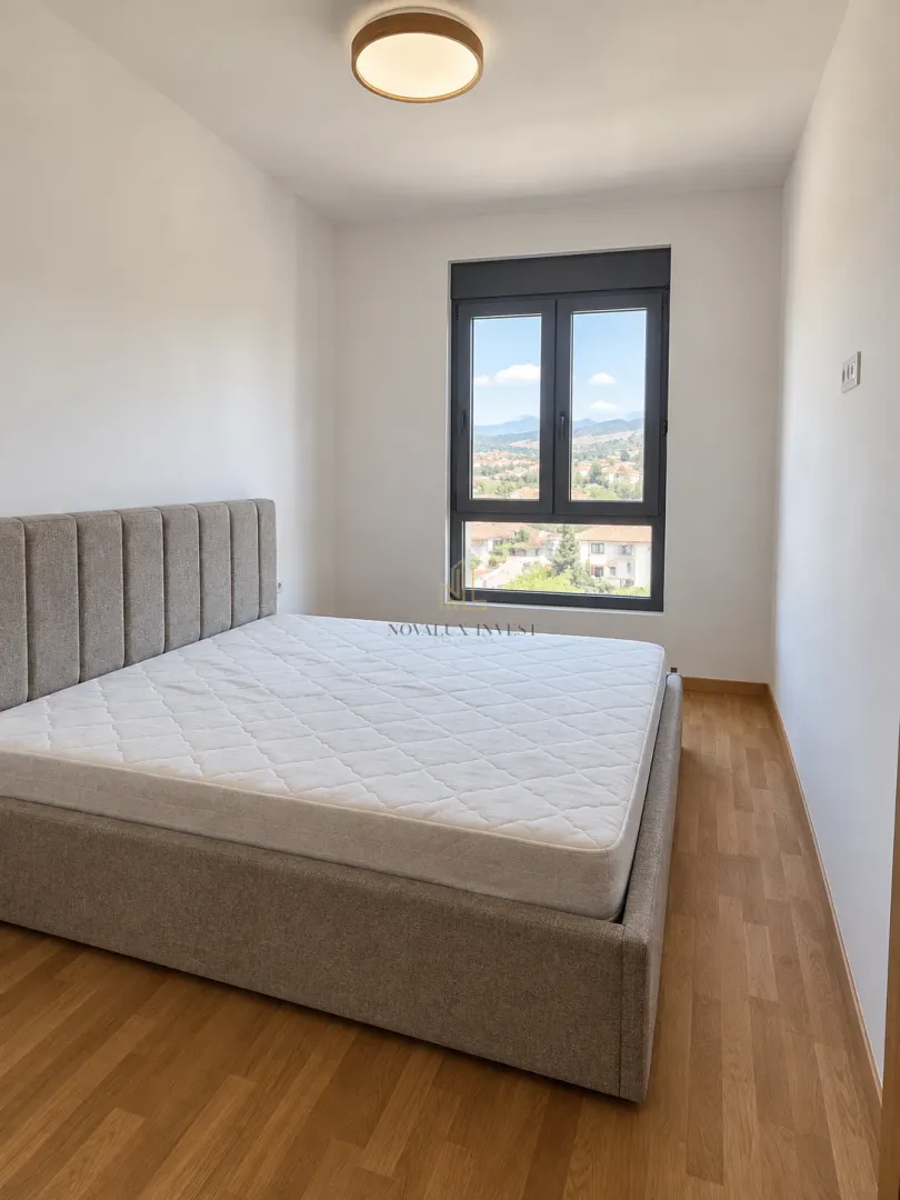 Bedroom with a double bed and a window overlooking the surroundings.