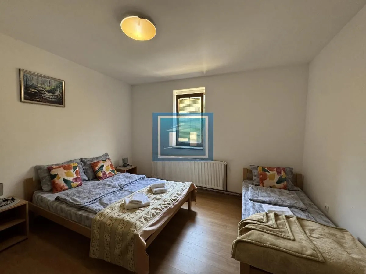 Bedroom with one double bed and one single bed.