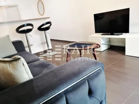 Living room with sofa, TV, and breakfast bar. - image 6