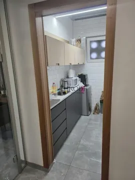 View of a small modernly equipped kitchen through the doorway. - image 13