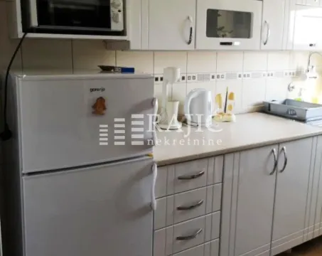 Small white kitchen with refrigerator and cabinets. - image 3
