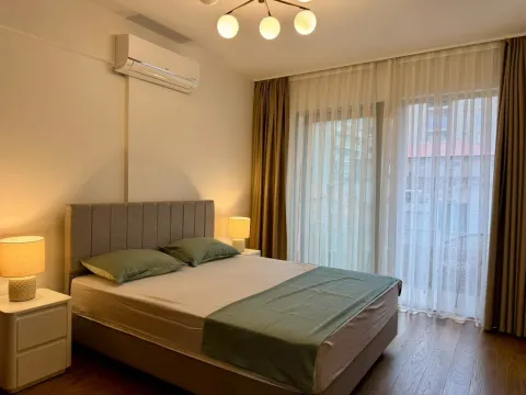 Furnished bedroom with a double bed, nightstands, and access to the terrace. - image 9